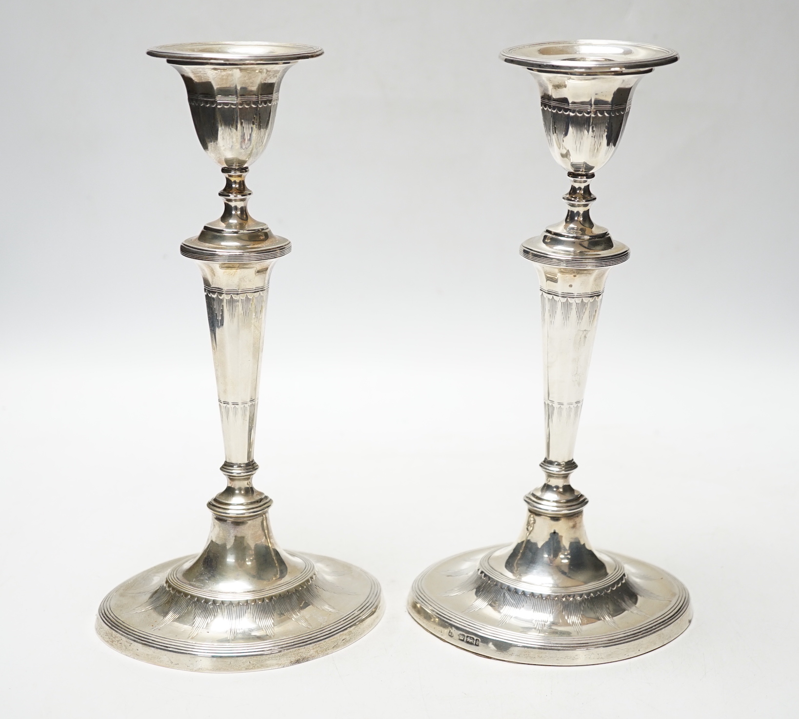 A pair of Edwardian silver mounted oval candlesticks, Thomas Bradbury & Sons, Sheffield, 1901, 23.4cm, weighted.
